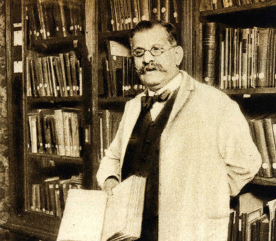 Magnus Hirschfeld inside the library of the Institute for Sexual Science (n. d.)